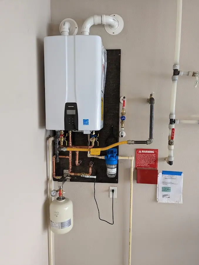 Professional plumber installing copper piping in a Goodview home